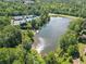 Sprawling aerial view showcases the lake, surrounding trees, and tennis courts at 238 Balsam Dr, Canton, GA 30114
