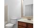 Powder room featuring a dark wood vanity, white sink, and a toilet at 238 Balsam Dr, Canton, GA 30114