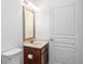 Powder room featuring white countertops, dark wood vanity, and a mirror at 238 Balsam Dr, Canton, GA 30114