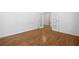 Bright bedroom featuring hardwood floors and white paneled doors leading to the bathroom at 238 Balsam Dr, Canton, GA 30114