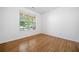 Sunlit bedroom featuring a large window and classic hardwood flooring at 238 Balsam Dr, Canton, GA 30114