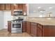 Kitchen features stainless steel appliances, dark cabinetry, and hardwood floors, perfect for cooking and entertaining at 238 Balsam Dr, Canton, GA 30114