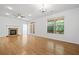 Spacious living room boasts hardwood floors, fireplace, ceiling fan and natural light from large windows at 238 Balsam Dr, Canton, GA 30114
