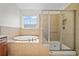 Main bathroom featuring a separate shower, soaking tub, and tiled floors at 238 Balsam Dr, Canton, GA 30114