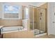 Main bathroom featuring a soaking tub, separate shower, and tiled surround at 238 Balsam Dr, Canton, GA 30114