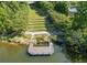 Scenic pond with a wooden dock and terraced landscaping in a lush, green setting at 238 Balsam Dr, Canton, GA 30114