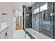 Glass-enclosed shower with a built-in bench and modern fixtures is featured in the bathroom at 1240 Hayes Sq, Peachtree City, GA 30269