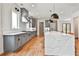 Gorgeous modern kitchen has gray cabinets, an island with seating, and stainless appliances at 1240 Hayes Sq, Peachtree City, GA 30269