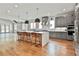 Spacious open kitchen with quartz counters, stainless appliances, and island with barstool seating at 1240 Hayes Sq, Peachtree City, GA 30269