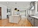 Modern kitchen features stainless appliances, gas range, and large island with seating at 1240 Hayes Sq, Peachtree City, GA 30269