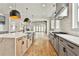Open kitchen with gas range, light wood floors and oversized island with a stainless sink at 1240 Hayes Sq, Peachtree City, GA 30269