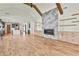 Open-concept living room with hardwood floors and a modern fireplace at 1240 Hayes Sq, Peachtree City, GA 30269
