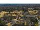 Aerial view of the home situated on the golf course with lush greenery and mature trees at 1460 Lakemist Ct, Roswell, GA 30075