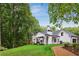 Expansive backyard featuring a well-maintained lawn, mature trees, and a charming outdoor living area at 1460 Lakemist Ct, Roswell, GA 30075