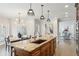 Open kitchen with a central island, pendant lighting, and an adjacent dining area at 1460 Lakemist Ct, Roswell, GA 30075