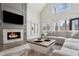 Bright living room with a fireplace and large windows offers natural light and a cozy atmosphere at 1460 Lakemist Ct, Roswell, GA 30075