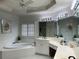 Bright and airy bathroom featuring a jacuzzi tub, vanity and a fan for ventilation at 2612 Peterboro Row, Marietta, GA 30062