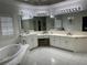 Bright white bathroom featuring and sinks, a vanity and a jacuzzi tub at 2612 Peterboro Row, Marietta, GA 30062