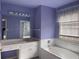 Bathroom featuring a soaking tub, tiled walls, and a vanity with a large mirror at 2612 Peterboro Row, Marietta, GA 30062