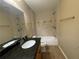 Well lit bathroom with granite topped vanity, tiled floors, and shower over tub at 2612 Peterboro Row, Marietta, GA 30062