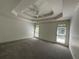 Large bedroom with a tray ceiling, neutral walls, carpeting, and two windows offering natural light at 2612 Peterboro Row, Marietta, GA 30062