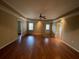 Large bedroom with hardwood floors, ceiling fan, neutral walls, and access to a private balcony at 2612 Peterboro Row, Marietta, GA 30062