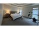 A brightly lit and spacious main bedroom with a queen-size bed, neutral walls, and a large window at 2612 Peterboro Row, Marietta, GA 30062