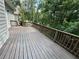Spacious wooden deck with brown railing, perfect for enjoying the private, wooded backyard at 2612 Peterboro Row, Marietta, GA 30062