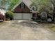 Traditional brick home featuring a two-car garage and a well-manicured front lawn at 2612 Peterboro Row, Marietta, GA 30062