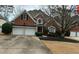 Charming two-story brick home with a well-manicured lawn and a two-car garage in a suburban neighborhood at 2612 Peterboro Row, Marietta, GA 30062