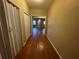 Long hallway with hardwood floors and storage closets leading to a spacious living area at 2612 Peterboro Row, Marietta, GA 30062