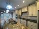 Open kitchen features a large granite island, stainless steel appliances, and a breakfast nook with a view at 2612 Peterboro Row, Marietta, GA 30062