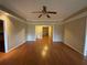 Open living room featuring hardwood floors, neutral walls, and a ceiling fan at 2612 Peterboro Row, Marietta, GA 30062