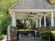 Outdoor lounge with tables and chairs, featuring ceiling fans, and overlooking lush greenery at 2612 Peterboro Row, Marietta, GA 30062