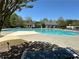 Community pool surrounded by lush landscaping and with ample lounge seating for residents at 2612 Peterboro Row, Marietta, GA 30062
