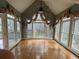 Bright sunroom featuring hardwood floors and large windows offering scenic views at 2612 Peterboro Row, Marietta, GA 30062