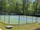 Well-maintained tennis court within the community, surrounded by trees for privacy at 2612 Peterboro Row, Marietta, GA 30062