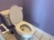 Standard toilet in a bathroom with purple walls and white tile flooring at 2612 Peterboro Row, Marietta, GA 30062