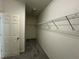 Walk-in closet with shelving and carpet flooring, providing ample storage space at 2612 Peterboro Row, Marietta, GA 30062