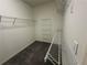 Well-organized walk-in closet with shelving, carpet flooring, and built-in storage solutions at 2612 Peterboro Row, Marietta, GA 30062