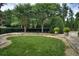 Well-manicured backyard with lush lawn, mature trees, manicured hedges, and privacy fence at 700 Park Regency Ne Pl # 805, Atlanta, GA 30326
