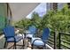 Outdoor balcony with seating featuring 3 blue chairs and a table at 700 Park Regency Ne Pl # 805, Atlanta, GA 30326