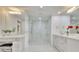 Bright bathroom featuring a marble-tiled shower, double vanity, and modern fixtures at 700 Park Regency Ne Pl # 805, Atlanta, GA 30326