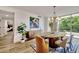 Elegant dining area with a chandelier, modern sideboard, and scenic views from the large windows, seamlessly blending style at 700 Park Regency Ne Pl # 805, Atlanta, GA 30326