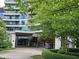 Grand entrance with a covered portico, manicured landscaping, and elegant architectural details at 700 Park Regency Ne Pl # 805, Atlanta, GA 30326