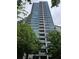 Modern high-rise building featuring multiple balconies and floor-to-ceiling windows surrounded by mature trees at 700 Park Regency Ne Pl # 805, Atlanta, GA 30326