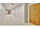 Well-lit hallway with neutral carpeting, leading to unit #805, marked by a light-wood door at 700 Park Regency Ne Pl # 805, Atlanta, GA 30326