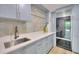 Kitchen features a stylish backsplash, stainless sink and integrated refrigerator at 700 Park Regency Ne Pl # 805, Atlanta, GA 30326