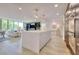 Open-concept living space with a stylish kitchen island, comfortable living area, and a view of the trees at 700 Park Regency Ne Pl # 805, Atlanta, GA 30326