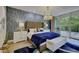 Luxurious main bedroom featuring a tufted headboard, decorative lighting, and a private balcony offering serene views at 700 Park Regency Ne Pl # 805, Atlanta, GA 30326